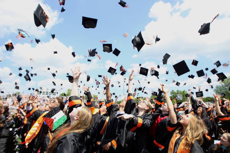Members of the Class of 2024 toss their caps to conclude McHenry High School’s 104th Annual Commencement at McCracken Field on Saturday.