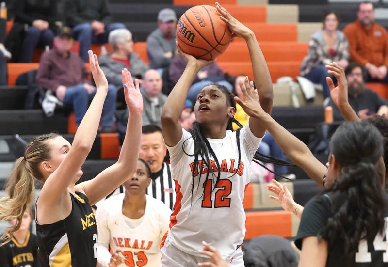 DeKalb’s Brytasi Long gets up a shot between two Metea Valley defenders during their game Friday, Jan. 19, 2024, at DeKalb High School.