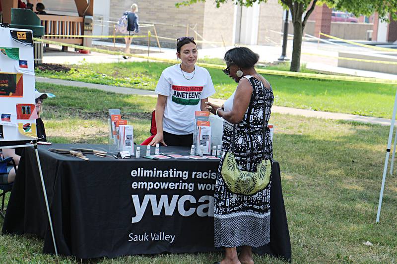 Cassandra Salmon (left) speaks with Joan Leblanc Saturday, June 17, 2023 about how the YWCA helps those in need during a Sterling Junteenth celebration.