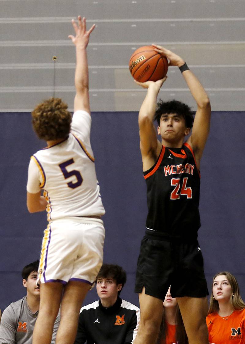 McHenry's Adam Anwar shoots a three-pointer over Hononegah's Landon Claudy during the IHSA Class 4A Guilford Boys Basketball Sectional semifinal game on Wednesday, Feb. 28, 2024, at Rock Valley College in Rockford.