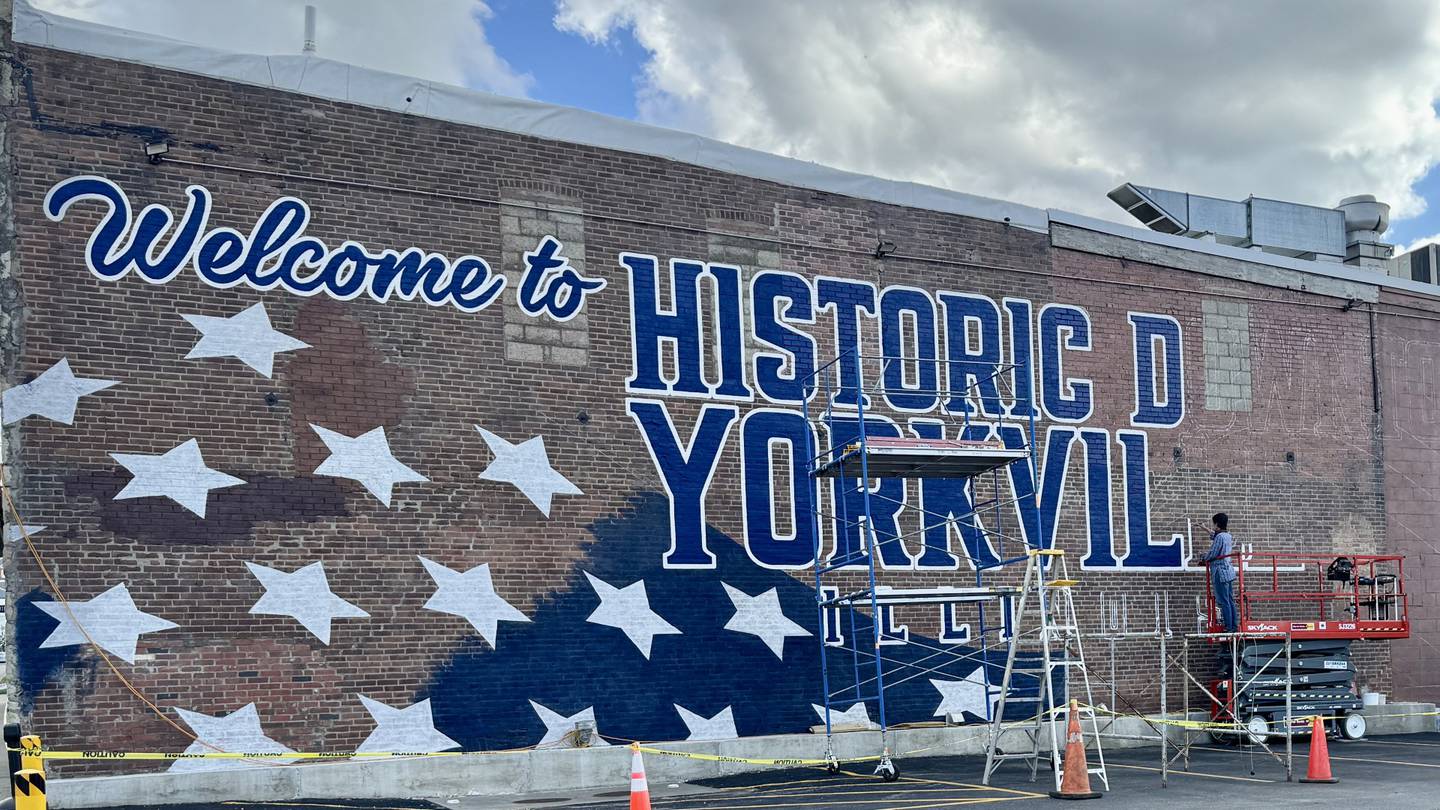 Artist Joshua Schultz works on Yorkville’s newest mural on the north side of Crusade Burger Bar at 209 S Bridge St. in downtown Yorkville.