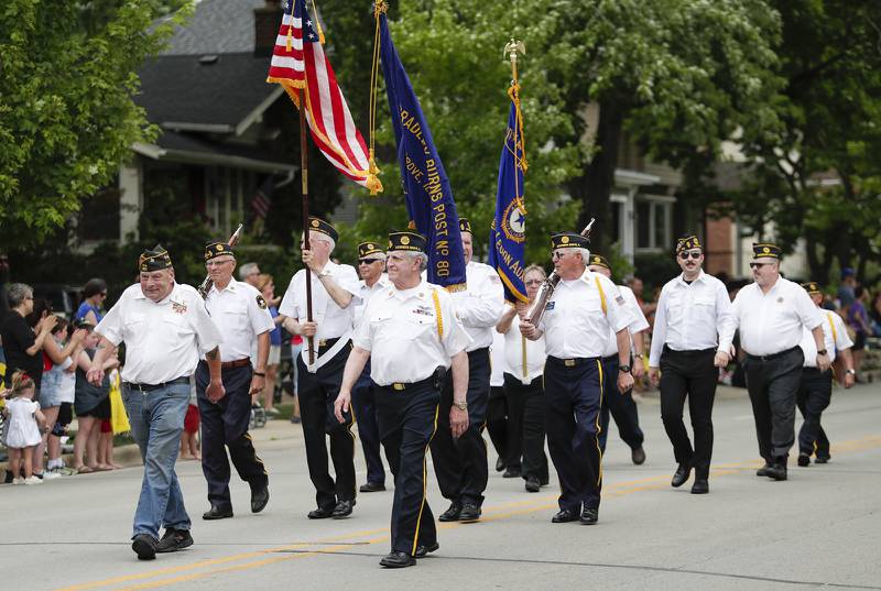 Members of American Legion Post 80 kick off the Independence Day parade in Downers Grove on Monday, July 4, 2022.