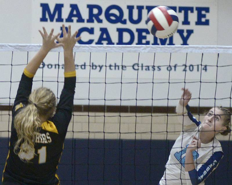 Marquette’s Kinley Rick sets to get the ball past the block attempt of Putnam County’s Kacie Coleman in the 1st set Thursday at Marquette.