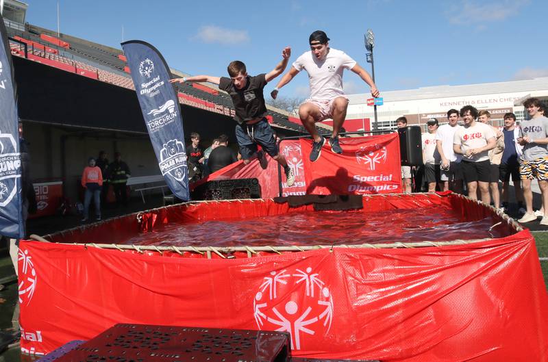 Members of the Phi Kappa Psi fraternity jump into the water on a cold and windy Saturday, Feb 17, 2024, during the Huskie Stadium Polar Plunge at Northern Illinois University in DeKalb. The Polar Plunge is the signature fundraiser for Special Olympics Illinois.