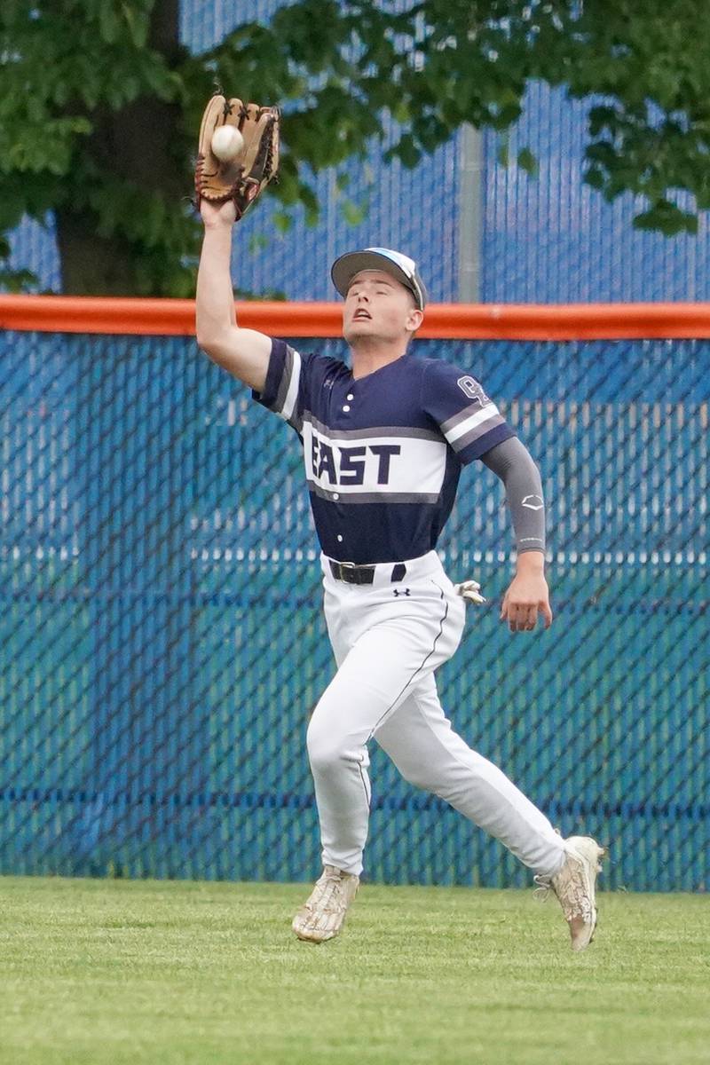 Oswego East's Will Bass (4) catches a fly ball for an out against Oswego during a baseball game at Oswego High School on Monday, May 13, 2024.