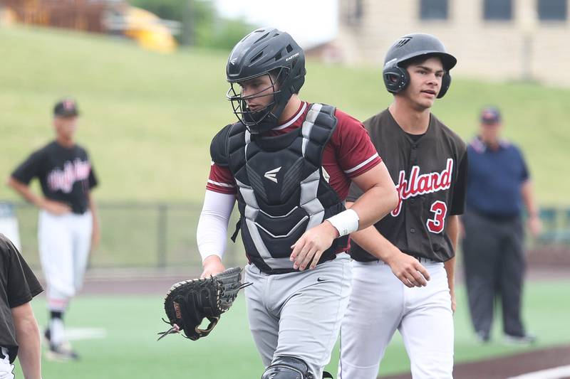 Morris’ Griffin Zweeres heads back to the plate after tagging out Highland’s Brayden Bircher on a premature run to the plate in the IHSA Class 3A 3rd place game on Saturday June 8, 2024 Duly Health and Care Field in Joliet.