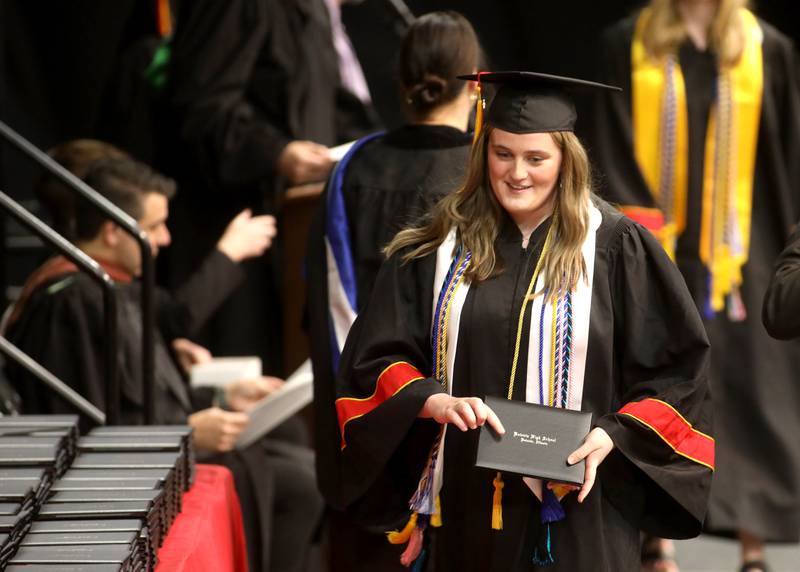 Batavia High School graduate Erin McLaughlin receives her diploma during the school’s 2024 commencement ceremony at Northern Illinois University in DeKalb on Wednesday, May 22, 2024.