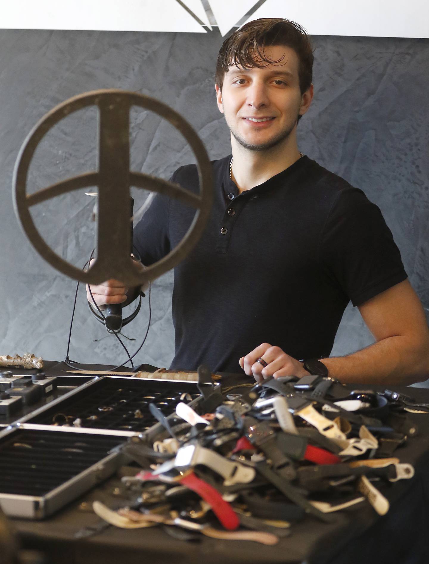 Darick Langos with some of the hundreds of items he has found with his metal detector on land or while diving in the Fox River or lakes.