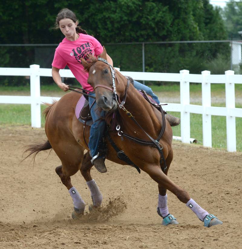 Molly Bettner, 16 of Oregon, steers DJ as they compete in the 18-under barrel competition at the WHOA benefit horse show on Saturday, June 22, 2024 at the Whiteside County fairgrounds in Morrison..