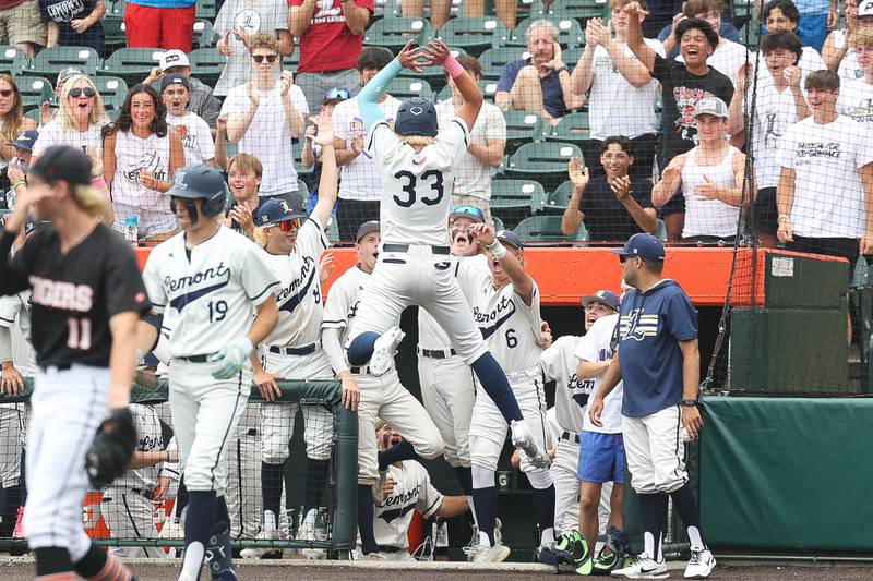 Lemont’ Cannon Mades jumps into the dugout after scoring on a dropped called strike against Crystal Lake Central in the IHSA Class 3A Championship game on Saturday June 8, 2024 Duly Health and Care Field in Joliet.