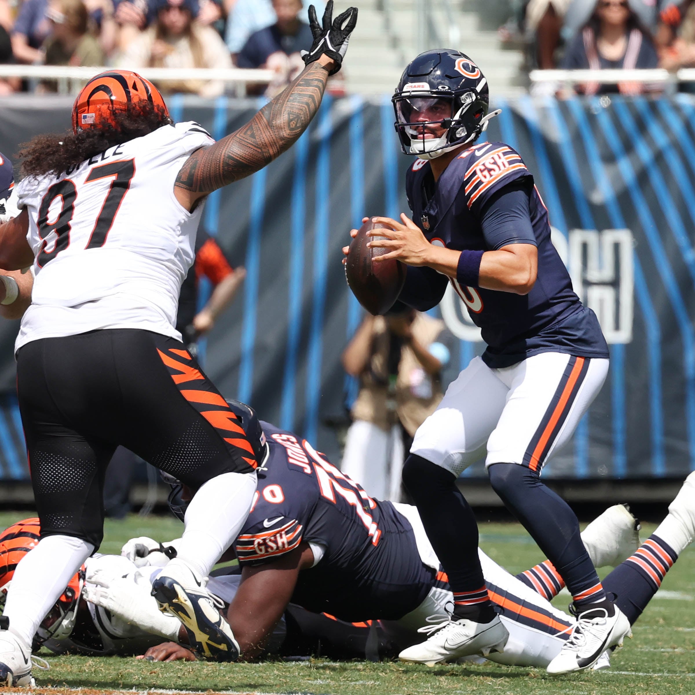 Chicago Bears quarterback Caleb Williams looks for a receiver as Cincinnati Bengals defensive tackle Jay Tufele pressures him during their game Saturday, Aug. 17, 2024, at Soldier Field in Chicago.