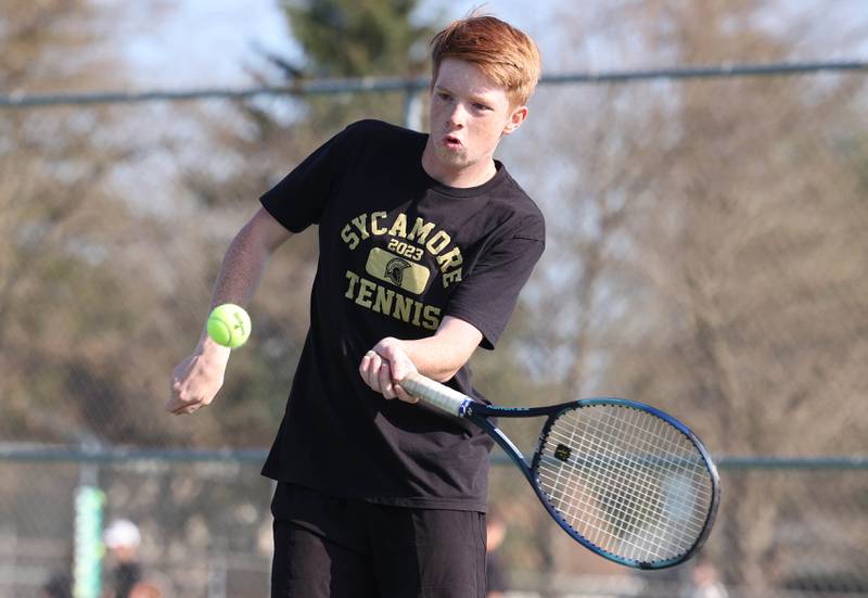 Sycamore number two doubles player Josh Plagakis hits a forehand Wednesday, April 26, 2023, during their match against DeKalb at Sycamore High School.