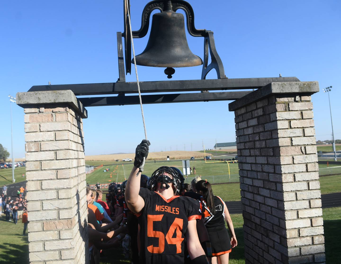 Milledgeville's Dalton Adamec rings the victory bell at Milledgeville High School after the Missiles 46-6 win over St. Thomas More in 8-man football on Saturday, Oct. 22. The Missiles ring the bell after every victory, including road wins.