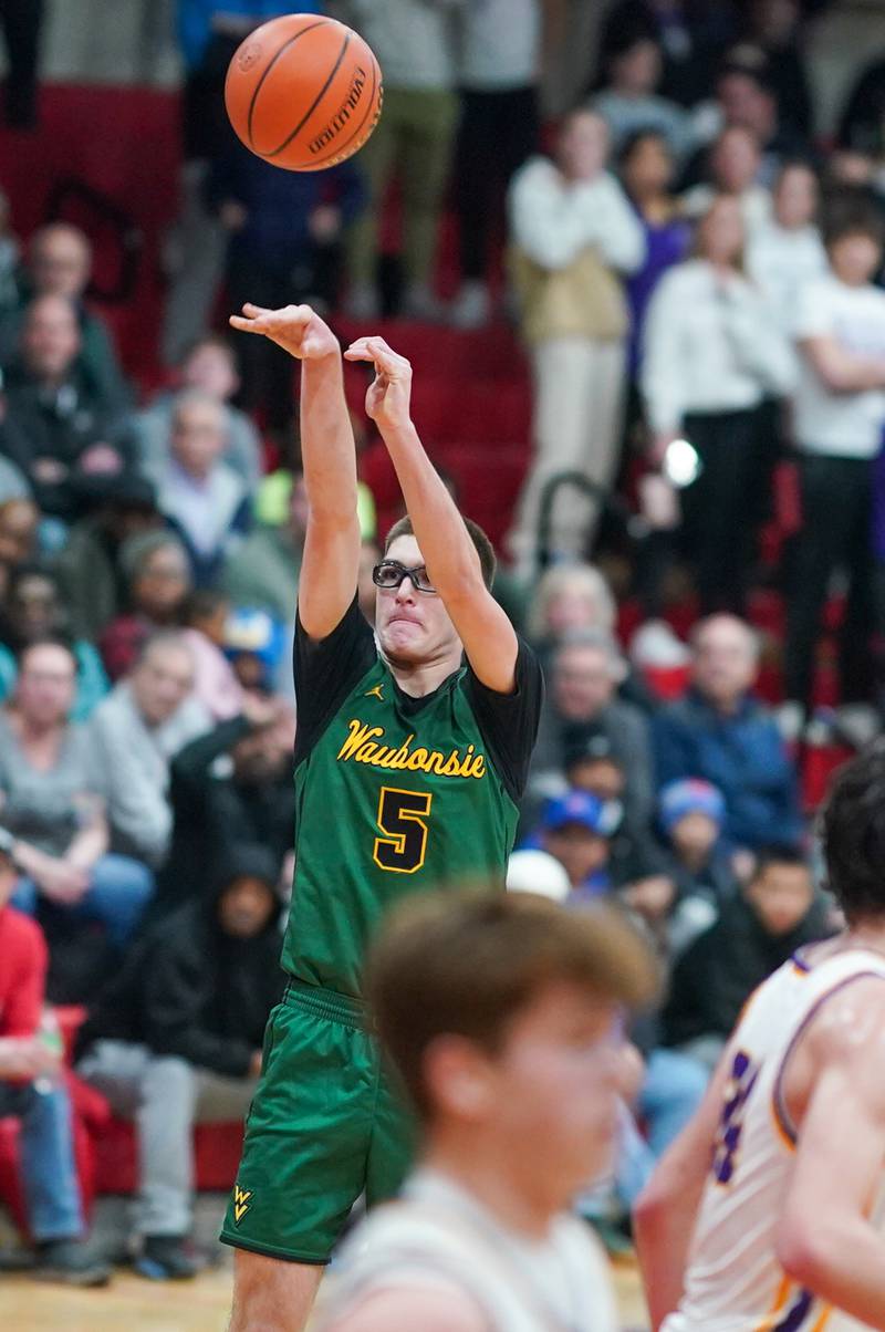 Waubonsie Valley's Ryan Morton (5) shoots a three pointer against Downers Grove North during a Class 4A East Aurora sectional semifinal basketball game at East Aurora High School on Wednesday, Feb 28, 2024.