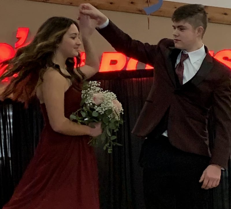 Runway models Ellie Kested and Sam Nieswander display a maroon ensemble as part of the Sauk Valley Wedding Expo held on Sunday at Northland Mall in Sterling.