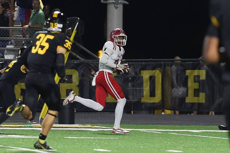 Yorkville’s Dyllan Malone turns upfiled after a catch for a touchdown against Joliet West on Friday, Sept. 13, 2024 in Joliet.