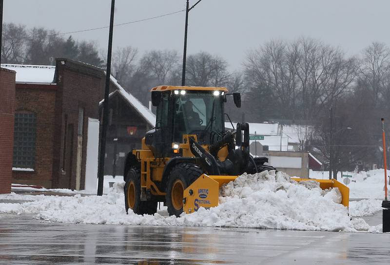 A excavator plows a large amount of snow off of 2nd Street on Friday, Jan. 12, 2024 downtown La Salle.