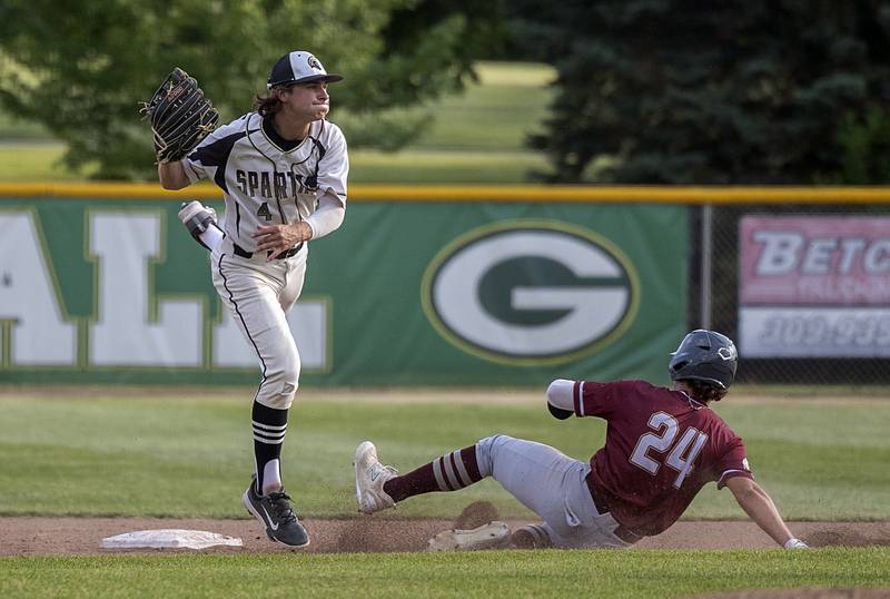 Sycamore’s Collin Severson fires to first in an attempt for the double play against Morris’ Colin Pfeifer Monday, June 3, 2024 in the Class 3A Geneseo supersectional.