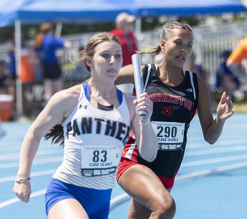 Forreston’s Letrese Buisker (right) looks to pick up speed in the 1A 4x200 Saturday, May 18, 2024 at the IHSA girls state track meet in Charleston.