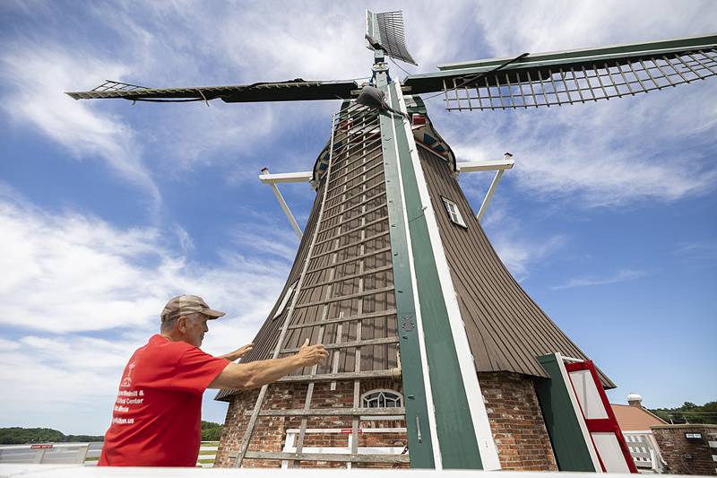 Larry Russell talks about the structure of the de Immigrant, the Fulton windmill Friday, June 7, 2024. The wind powered machine generates 100 horsepower for grinding grain.