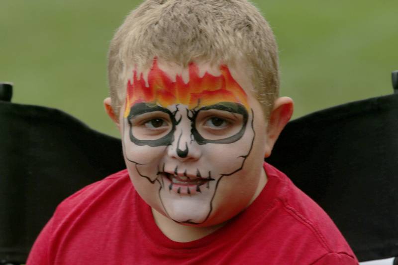 Blake Jutton smiles after having his face painted during the National NIgh Out event on Tuesday, Aug. 6, 2024 at Zearing Park in Princeton.