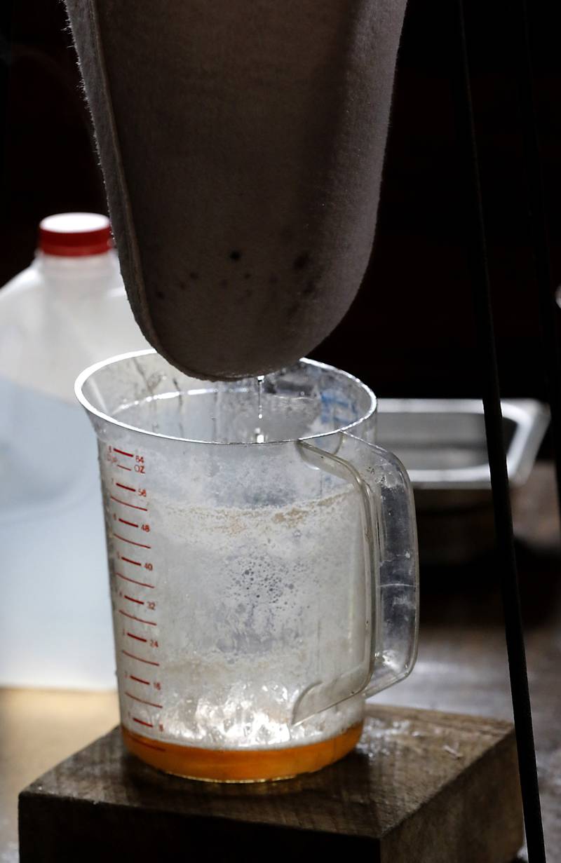 Maple syrup is filtered as Chuck Howenstine makes maple syrup on Thursday, March 9, 2023, at the Pioneer Tree Farm near McHenry. Howenstine has been collecting sap for most of his adult life to make maple syrup that he gives away.