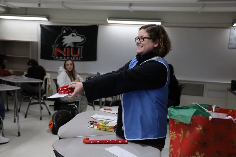 Kelsey Podgorski, assistant director of multilingual education at McHenry High School, delivers a pen pal's letter and Christmas present to one of the English lab students on Tuesday, Dec. 19, 2023.