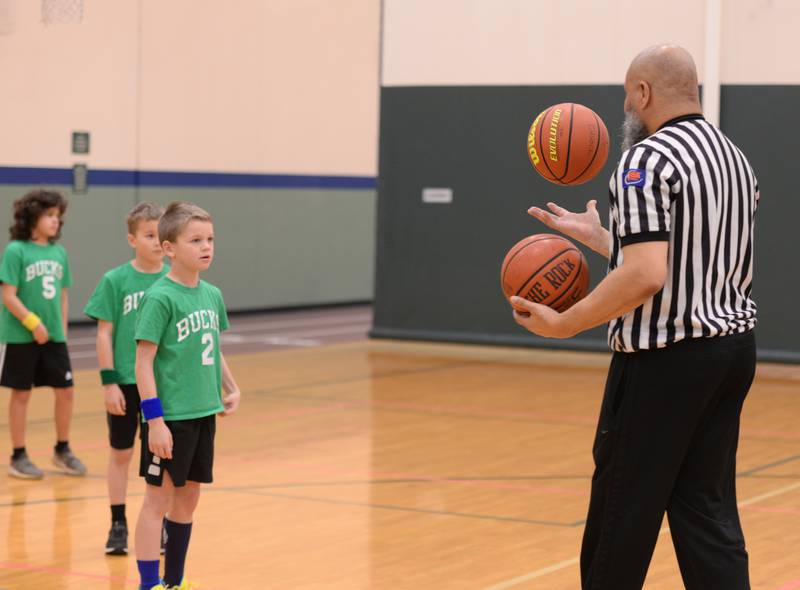 Graham Holstad awaits the referee's decision on which ball to use for their Youth Basketball game held at the LaGrange Park District Saturday, Jan 6, 2024.