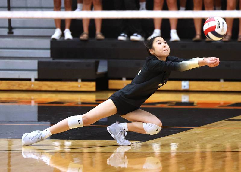 Sycamore's Inae Kim dives to receive a serve during their match against DeKalb Wednesday, Aug. 28, 2024, at DeKalb High School.