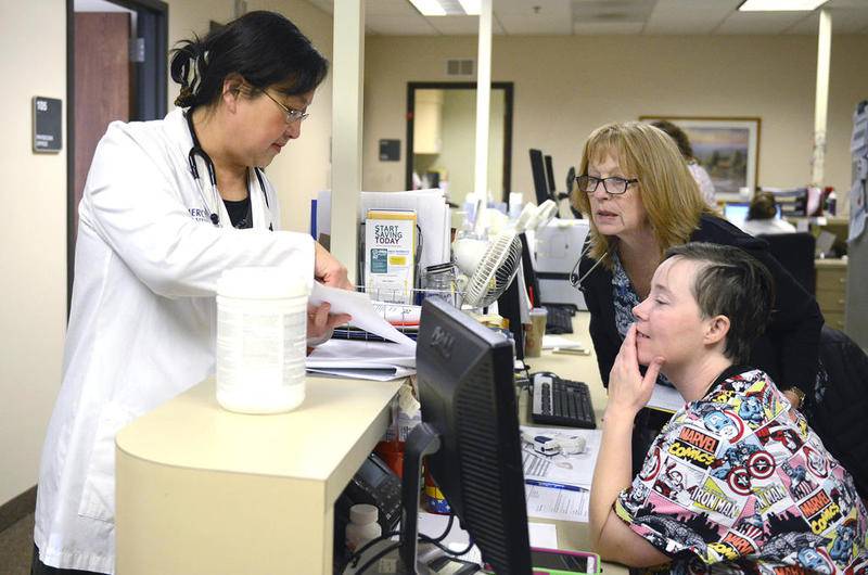 Dr. Emily Shen talks to nurses Casey Haefs (front) and Kathryn Olson in February about the day's schedule of appointments at the Mercyhealth clinic in Crystal Lake. A state board will vote Tuesday whether to grant Mercyhealth permission to build a 13-bed microhospital at the corner of Three Oaks Road and Route 31 in Crystal Lake.