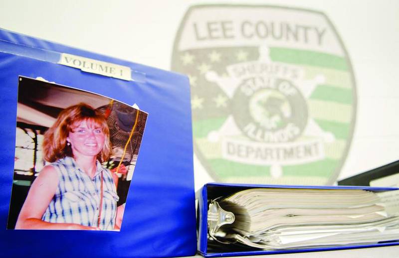 A photo of Amy Todd Fleming rests on the cover of one of the many evidence binders at the Lee County Sheriff's Department. The 20-year-old case has yet to be solved as detectives continue to seek justice.