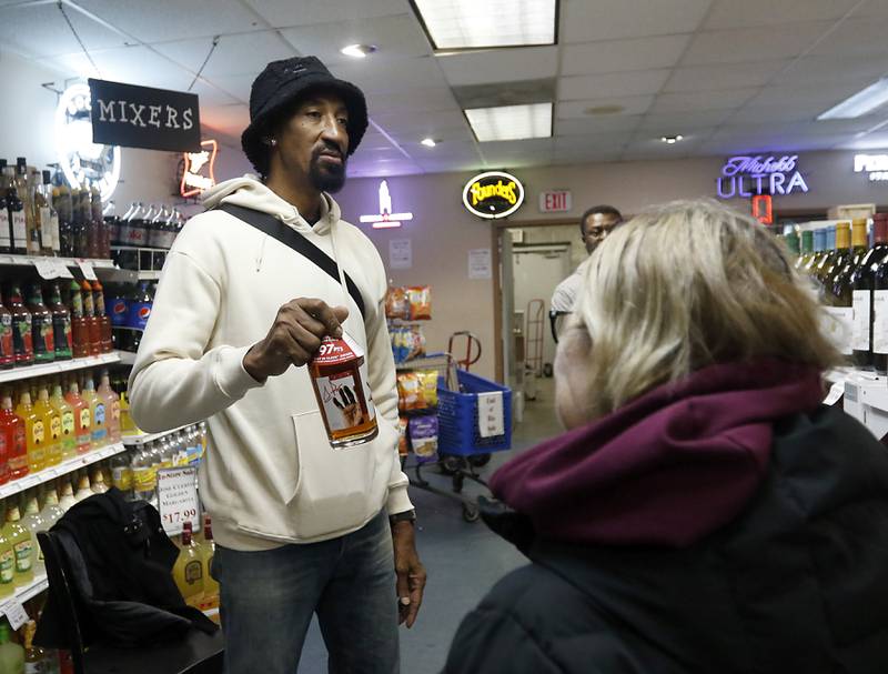 Retired Chicago Bulls star Scottie Pippen holds the up the last bottle of his Digits bourbon available to be signed on Thursday, Feb. 9, 2023, at The International House of Wine and Cheese, at 11302 Route 12, in Richmond.