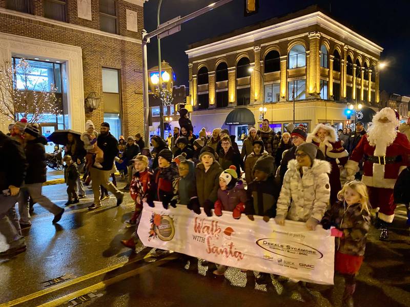 Children and families excited to meet the man from the North Pole marched along State Street with Santa Claus and Mrs. Claus in downtown Sycamore for Discover Sycamore's annual Walk with Santa on Friday, Dec. 1, 2023.