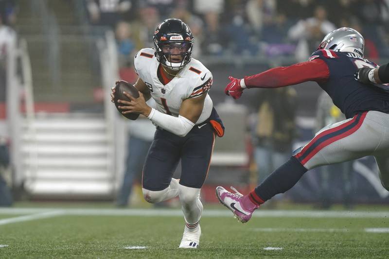 Chicago Bears quarterback Justin Fields tries to avoid pressure from New England Patriots linebacker Matthew Judon during the second half, Monday, Oct. 24, 2022, in Foxborough, Mass.