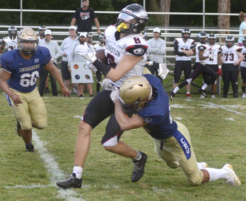 Marquette’s Payton Gutierrez tries to bring down Aurora Christian’s Jonan Miceli on a run in the 2nd quarter Friday at Marquette.