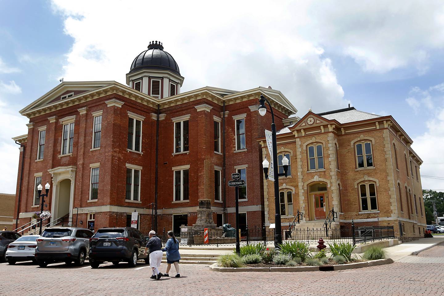 A couple walks in front of the newly renovated Old Courthouse Center in Woodstock during a tour of the building on Thursday, July 13, 2023.