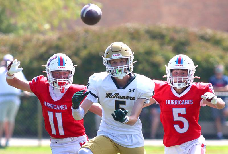 Marian Central’s Maxwell Kinney, left, and Michael Schmid, right, watch a pass intended for Bishop McNamara’s Richie Darr arrive in varsity football action on Saturday, Sept. 14, 2024, at George Harding Field on the campus of Marian Central High School in Woodstock. Schmid broke up the pass on the play.