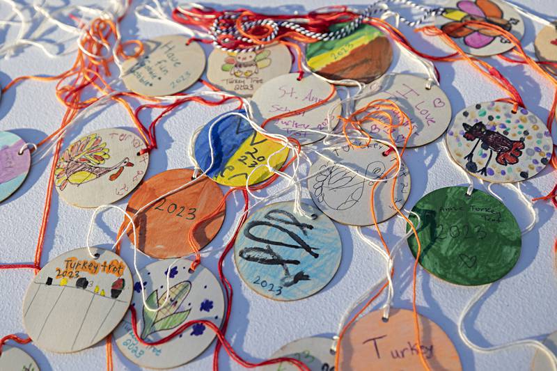 School children’s handmade medals were awarded to finishers of the St. Anne’s Turkey Trot Thursday, Nov. 23, 2023.