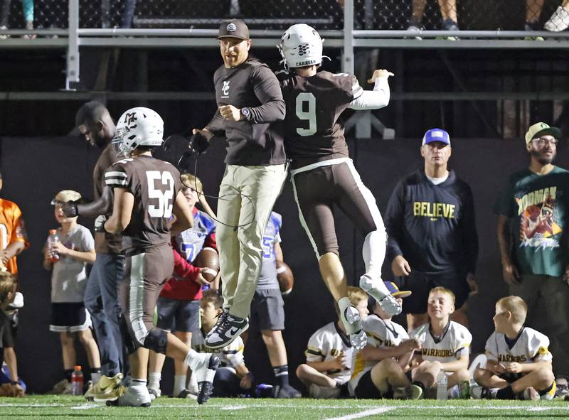 Mt. Carmel's Jack Eliott (9) is congratulated by head coach Jordan Lynch after a score during the varsity football game between Nazareth Academy and Mt. Carmel high school on Friday, Sep. 13, 2024 in Chicago.