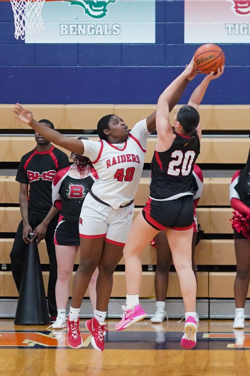 Bolingbrook's Jasmine Jones (40) blocks a shot by Benet’s Emma Briggs (20) during a Oswego semifinal sectional 4A basketball game at Oswego High School on Tuesday, Feb 20, 2024.