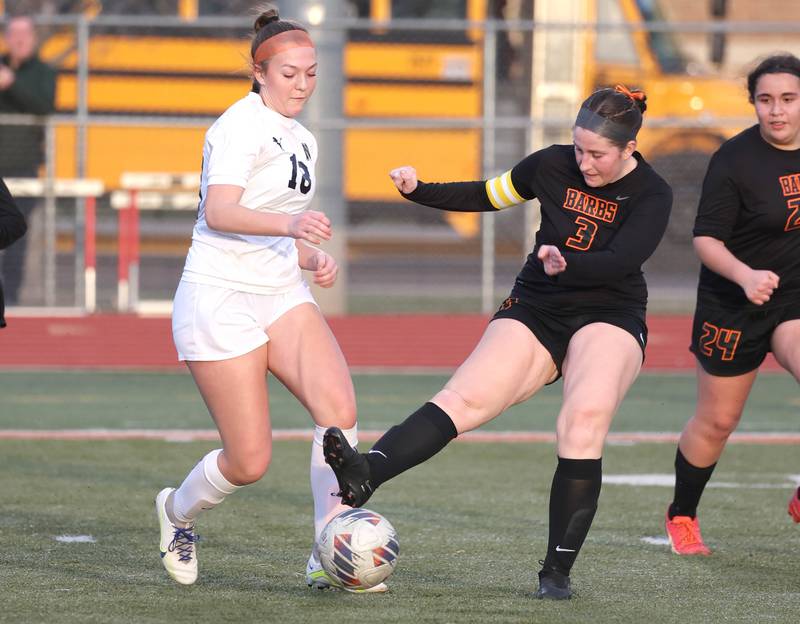 DeKalb's Isabella Schmerbach kicks the ball away from Belvidere North's Cortlyn Hefty during their game Tuesday, March 12, 2024, at DeKalb High School.