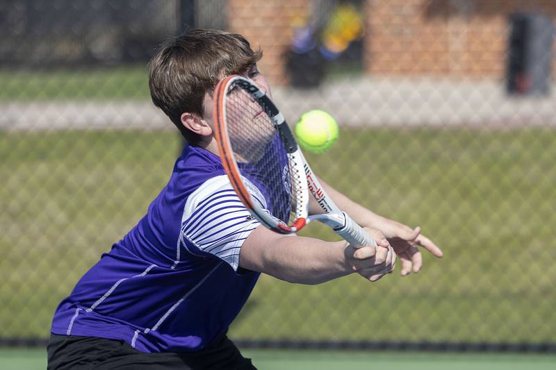 Dixon doubles player Owen Winters stretches for a shot against Sterling Thursday, May 4, 2023.
