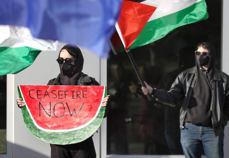 A protester holds a sign during a rally against the Israel–Hamas war Thursday, Feb. 29, 2024, outside the Holmes Student Center at Northern Illinois University in DeKalb.