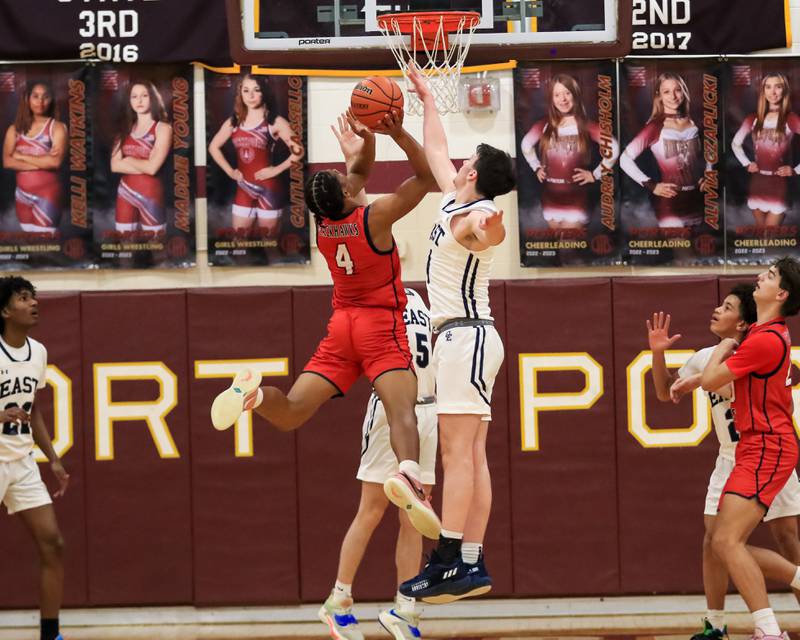 Oswego East's Tyler Jasek (4) goes up for the block on West Aurora's Josh Pickett (4) during Class 4A Lockport Regional final game between West Aurora at Oswego East.  Feb 24, 2023.