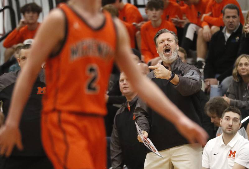 McHenry Head Coach Corky Card gives directing so his team during a nonconference basketball game against Antioch on Thursday, Jan. 4. 2024, at Antioch High School.