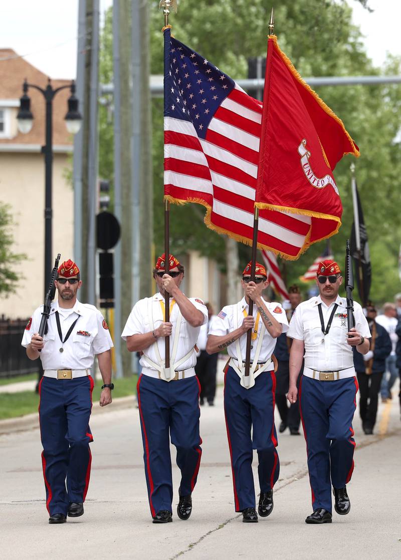 Members of the Marine Corps League Color Guard make the turn onto Linden Place from West Locust Street during the DeKalb Memorial Day parade Monday, May 27, 2024, on their way to Ellwood House for the ceremony.