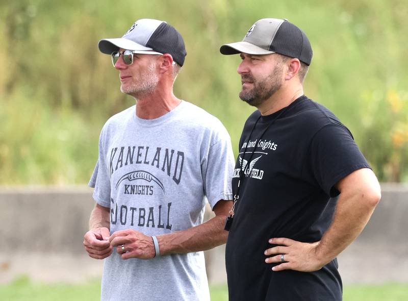 Kaneland football head coach Michael Thorgesen (right) talks to assistant coach Brian Aversa during practice Friday, Aug. 16, 2024, at the school in Maple Park.