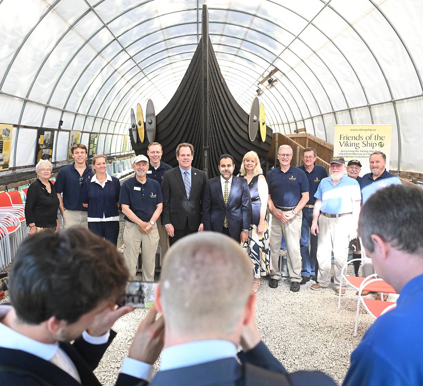 Norway's President of the Storting Masud Gharahkhani and members of his traveling party pose for photos with Geneva Mayor Kevin Burns and representatives of Friends of the Viking Ship at Good Templar Park in Geneva Friday.