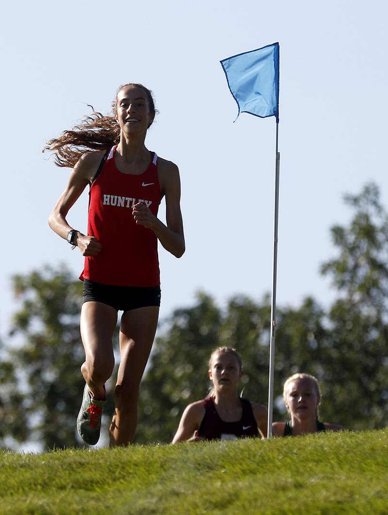 Huntley’s Breanna Burak leads the early part of the girls race of the McHenry County Cross Country Meet Saturday, August 27, 2022, at Emricson Park in Woodstock.