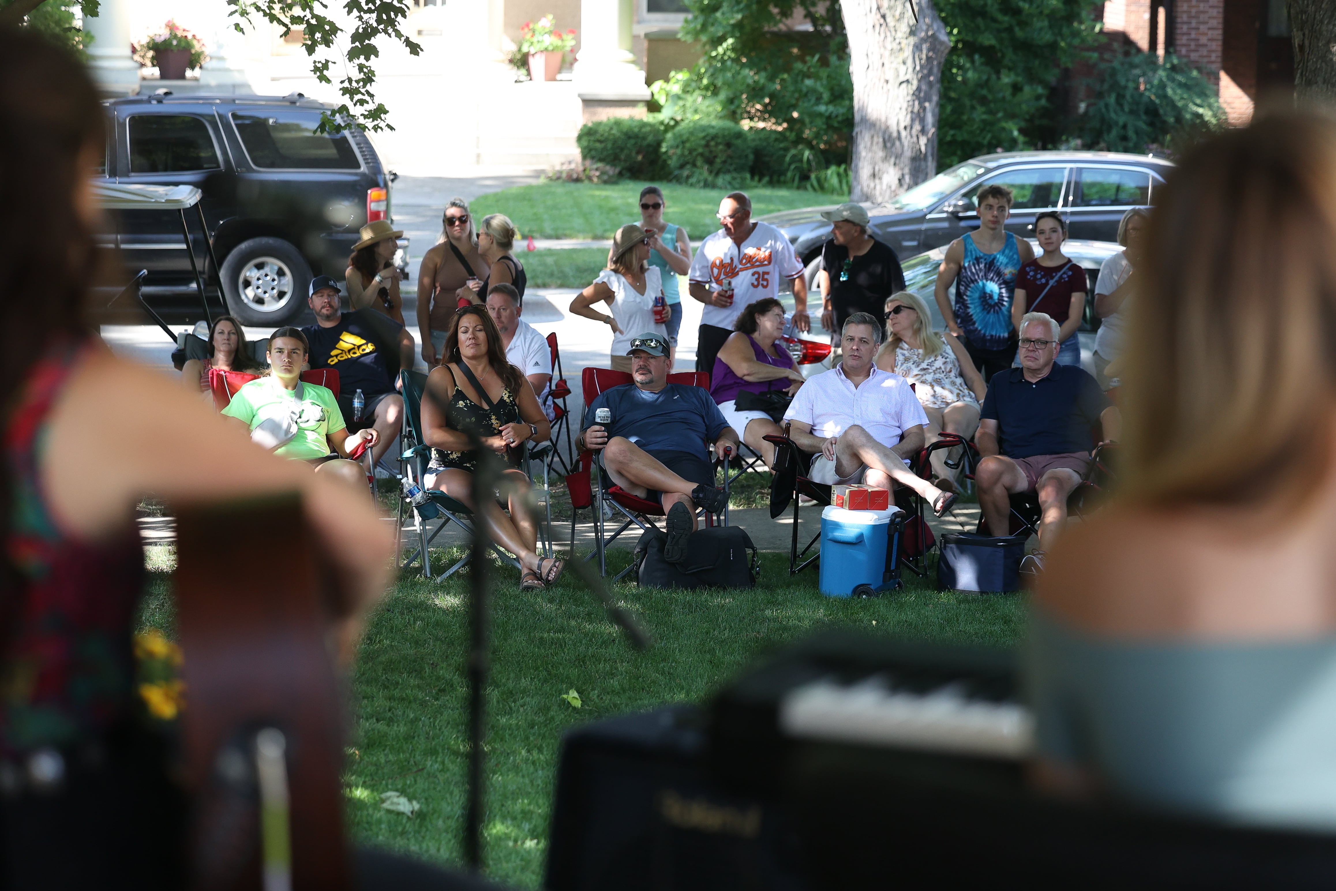 People pack the lawn of a home on the 600 block of Western Avenue listening to Katie Pederson and Jefferson Rinck perform on a porch at the annual Porch and Park Music Fest in the Upper Bluff Historic District in Joliet, Aug. 19, 2023.